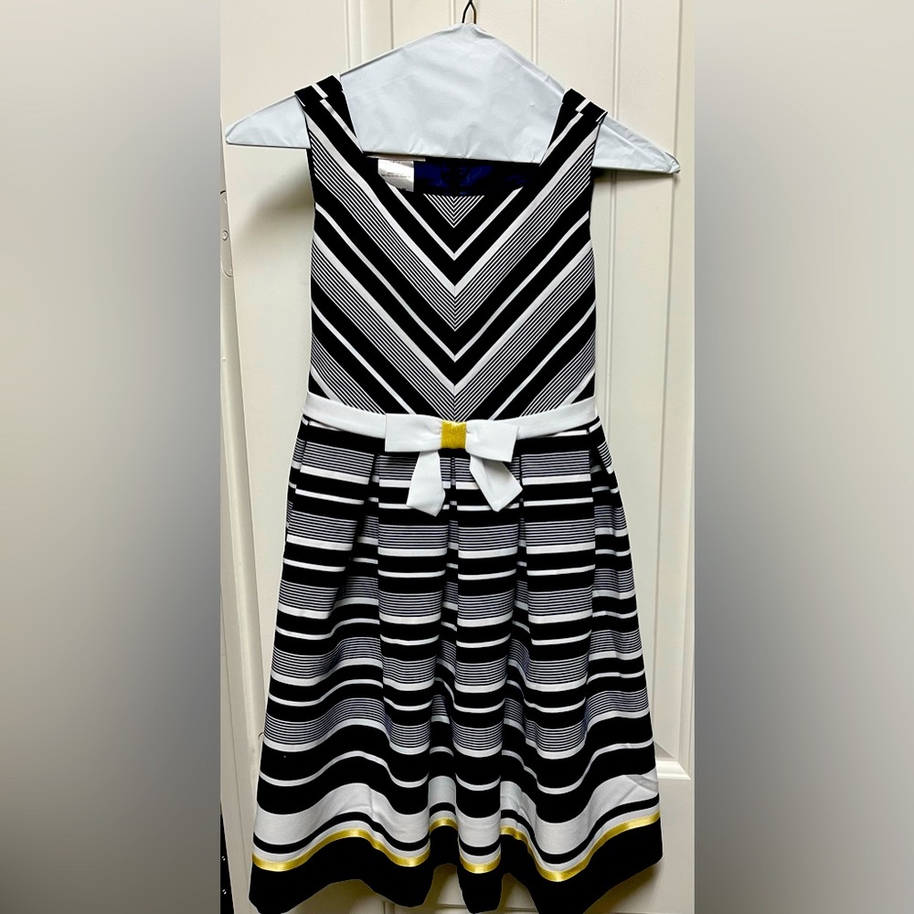 Blue, white trimmed in gold girl’s dress.